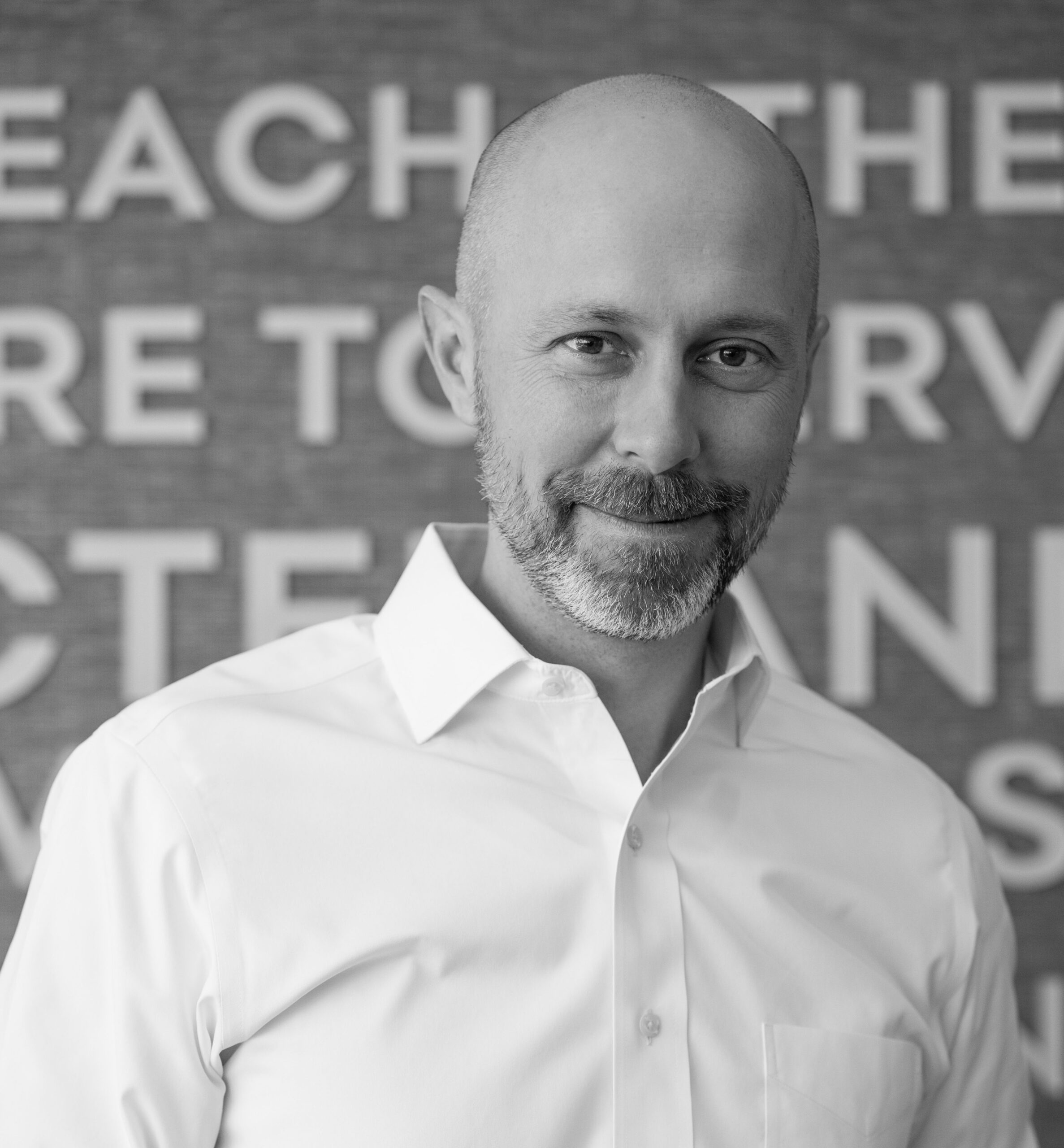 Insight Global CEO Bert Bean stands in front of his company's values.