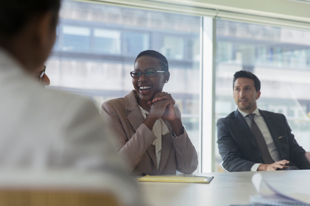 Laughing businesswoman in conference room meeting