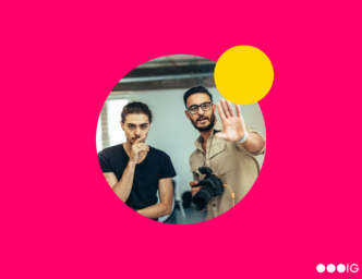 Circle cropped image of a male creative director explaining his vision to another man. Yellow accent circle. Magenta background.