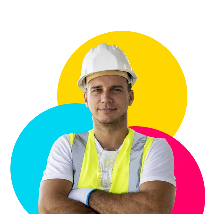 A man in a hard hat and safety vest that works with an industrial staffing agency.