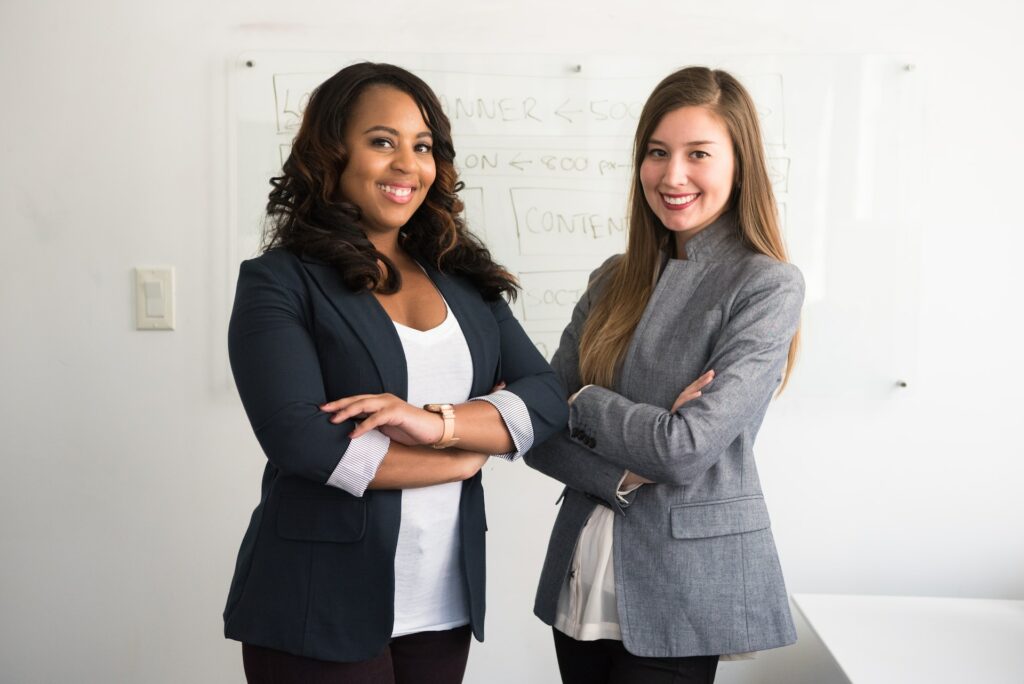 Leadership Development Program Women Leaders standing in front of a white board 