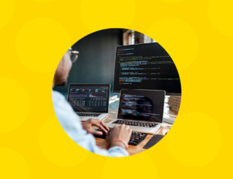 Yellow background surrounding a photo of a man sitting at multiple screens and devices What Kind of Developer Do You Really Need?