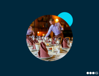 Image of server at a table in a restaurant hotel growth careers in hospitality industry