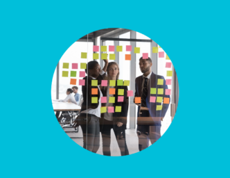 Blue background with round cutout showing three scrum masters working on a project with sticky notes planning Hiring a Scrum Master