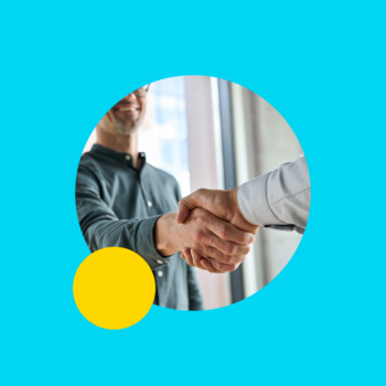 Man interviewing and shaking hands with another person.