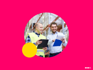 Two warehouse workers talking and looking at their clipboards